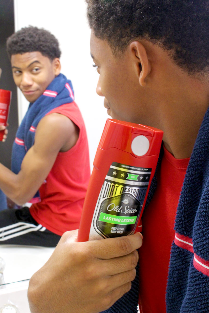 Teen in mirror with Old Spice Body Wash