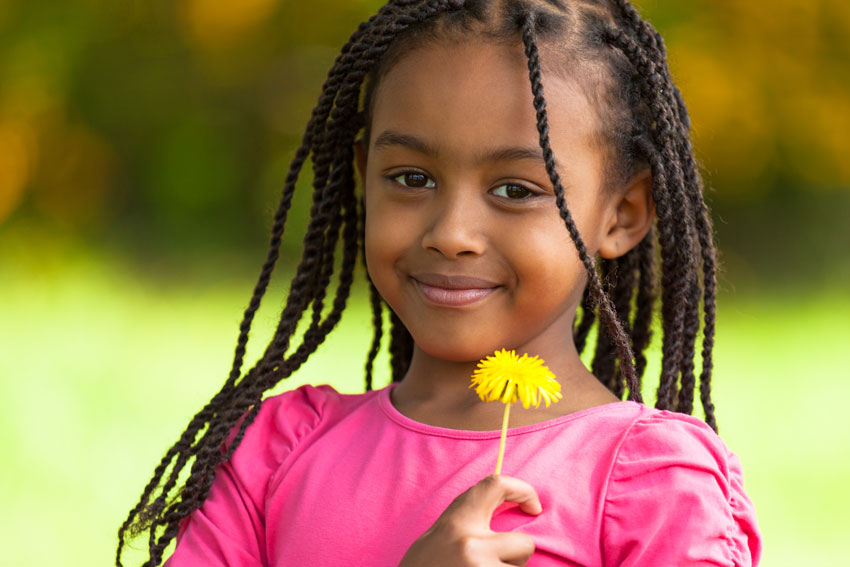 Caribbean Parenting Amongst the Weeds - Girl with dandelion flower