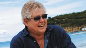 Gordon "Butch" Stewart wearing shades and a denim shirt smiling